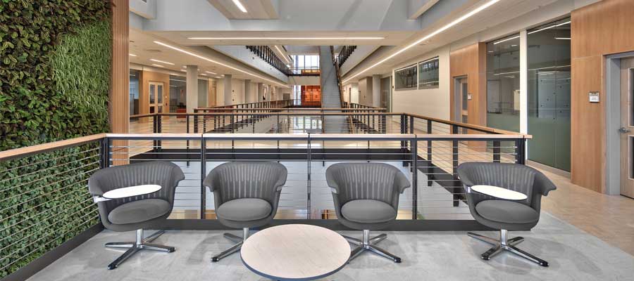RIT-GIS_Green-Wall Four chairs in hallway next to a live green wall.