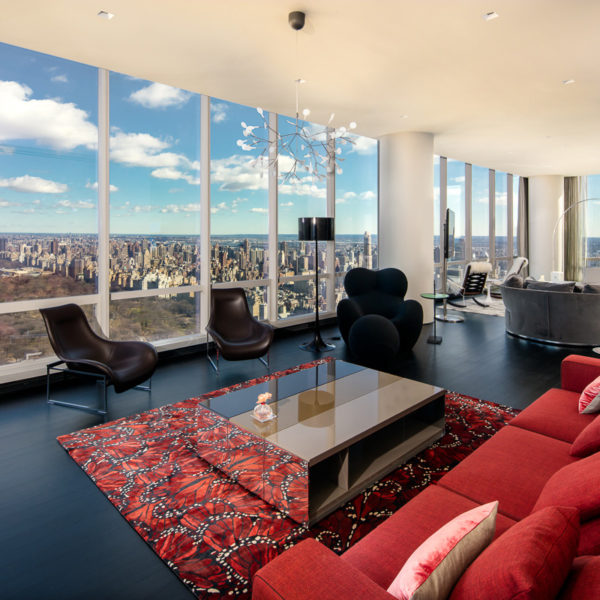 Large red couch, chairs and furnishings over looking the city skyline