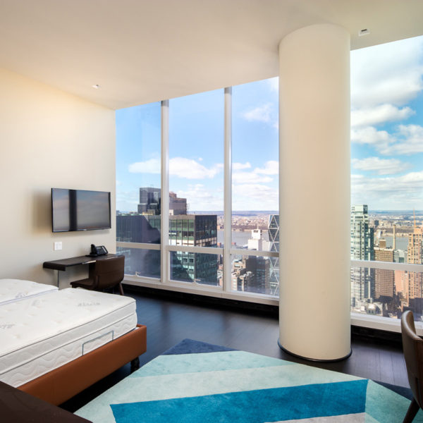 Bedroom with furnishings overlooking city skyline