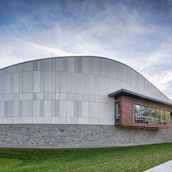 Exterior showing the curvature of the building against a blue sky.