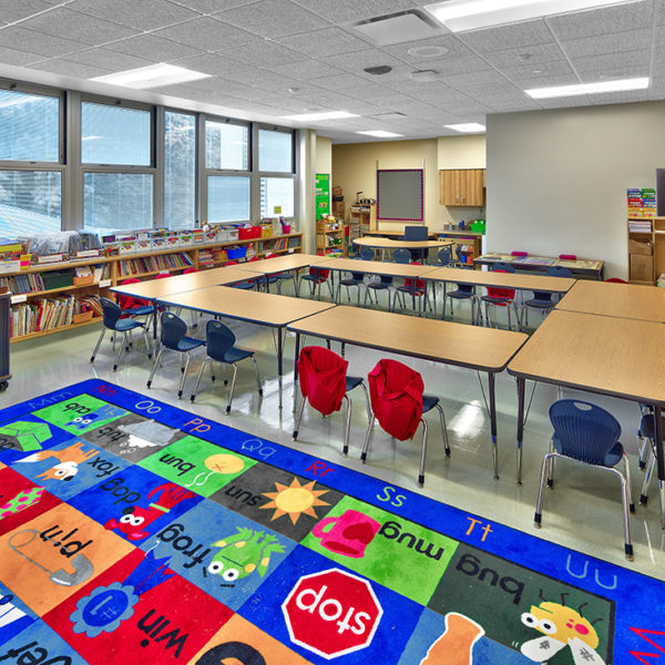 Elementary classroom with bright colored carpet and furniture