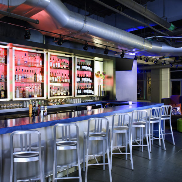 Large backlit bar with high-back bar chairs