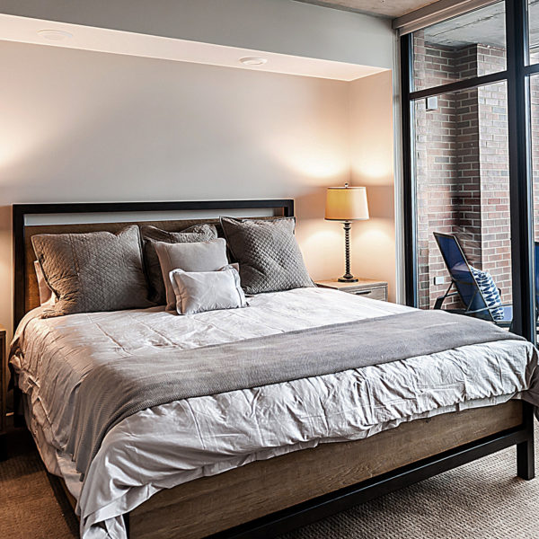 Apartment bedroom with king-size bed.