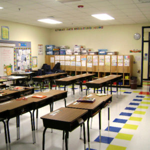 Classroom with desks, white board and cubbies