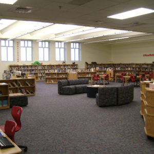 Library with book shelves along the walls and couches in the middle