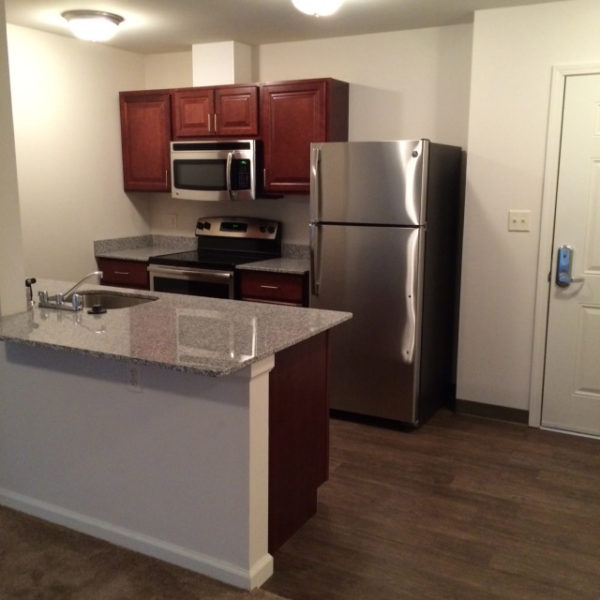 Apartment kitchen with stainless steel appliances and cabinets