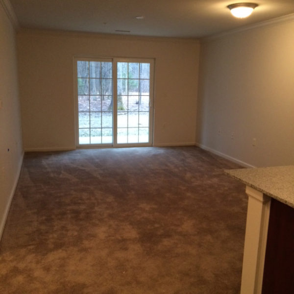 Empty room with carpet and sliding glass door