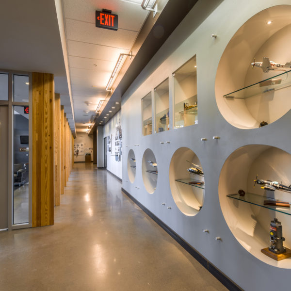 Office hallway with circle cut-outs in the wall showing history of the company