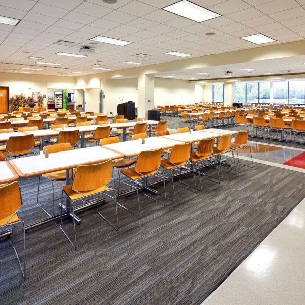 Large room with a lot of tables and chairs