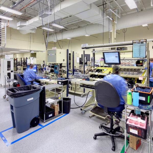 Manufacturing lab space with workers and equipment