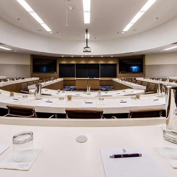 Large conference center room with semi circle tables and chairs