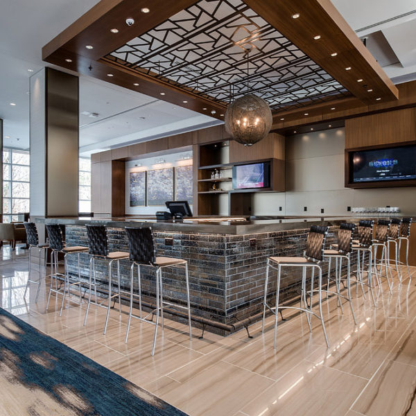 Lobby bar with high back chairs and high-end finishes