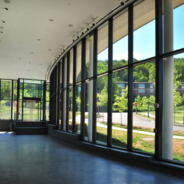 Curved glass wall, showing the mountains in the distance.