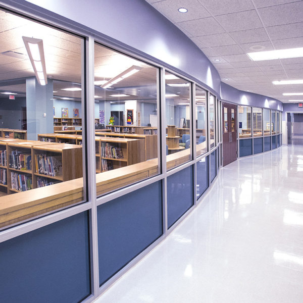 Hallway with glass windows overlooking library