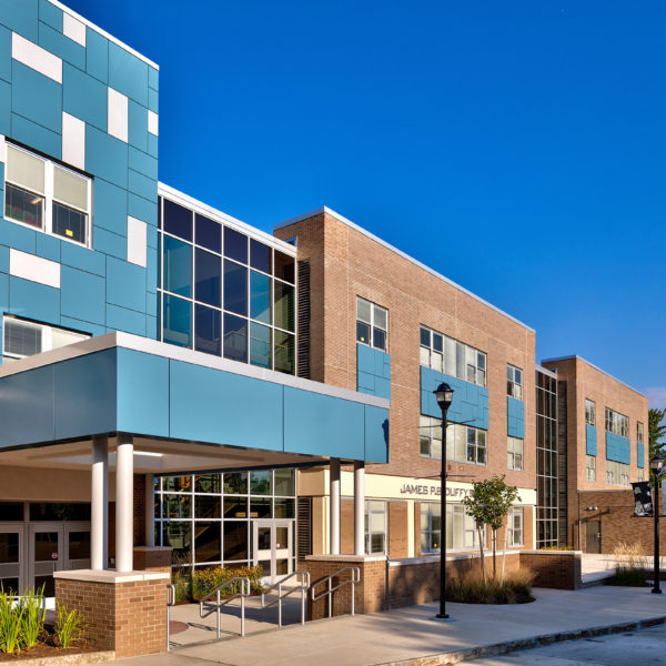 Exterior blue and brick facade of the school