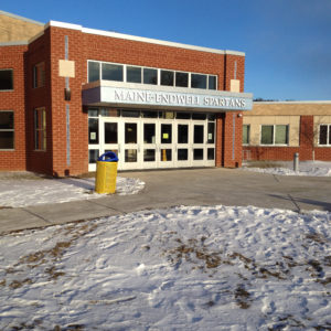 Entrance to school brick building with glass entrance doors
