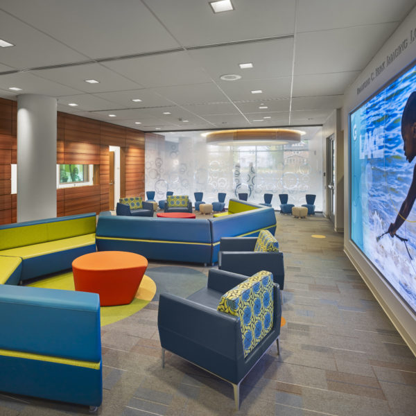 Lobby area with bright colored couches and chairs.