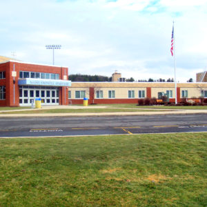 Exterior and main entrance of the school on a sunny day