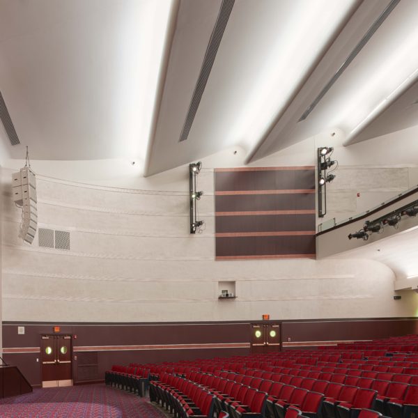 Auditorium from the side, with the stage to the left and seats to the right.