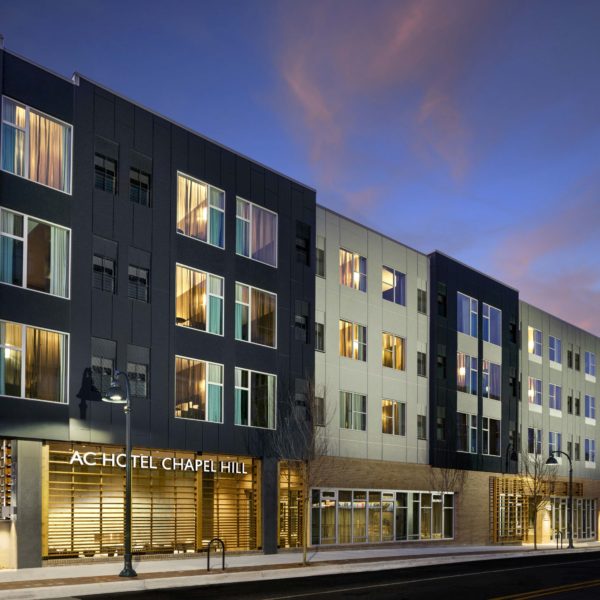 Angled exterior shot of hotel at dusk.