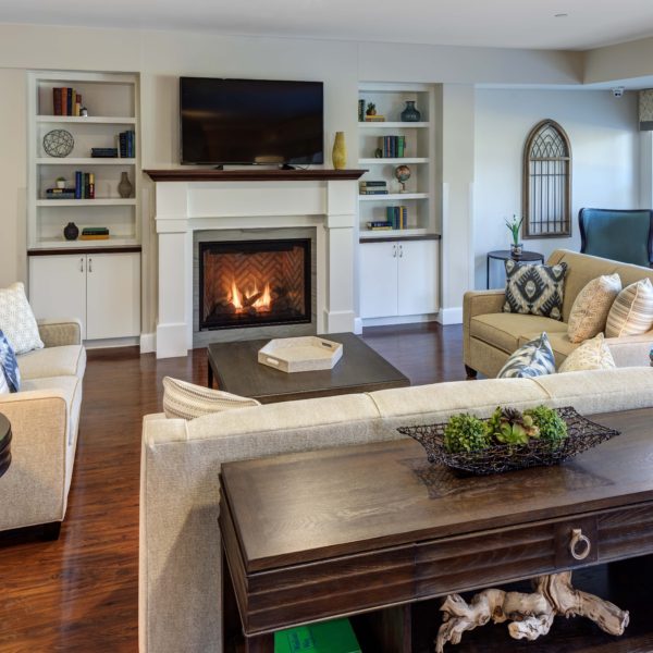 Sitting room with couches, fire place and finishes