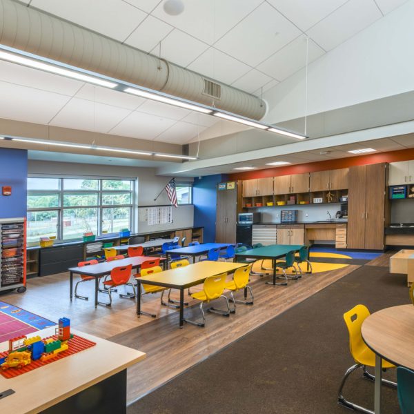 Kindergarten classroom with bright colored desks and furniture