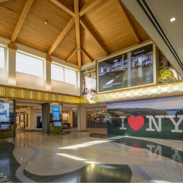 Welcome Center with I Love NY wall and wooden beam ceiling