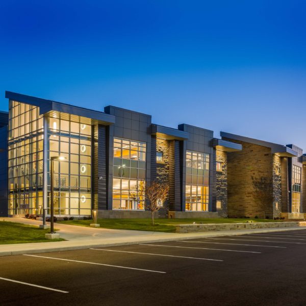 Dusk shot of school showing large glass windowns