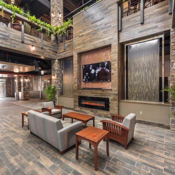 Dormitory lobby with couch, chairs, TV and fireplace