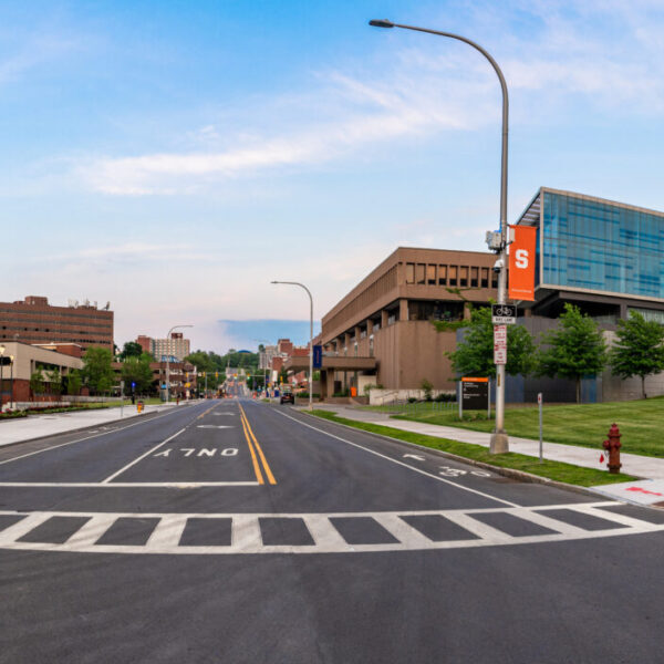 Exterior evening photo of the Daniel & Gayle D’Aniello National Veterans Resource Center better known as the NVRC. This is a 180 degree  panorama photo looking east down Waverly Ave.