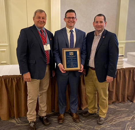 Mike Corey, accepts the Excellence in Partnering Award on behalf of the cleanroom project team