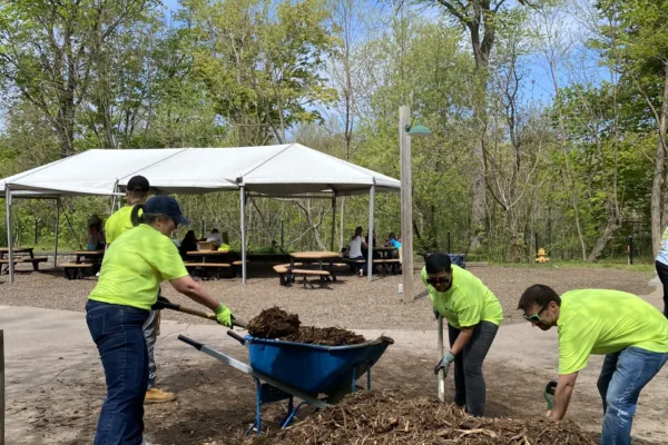 LeChase team shoveling mulch