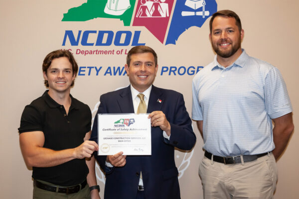 Spencer and Jacob accepting the NCDOL Safety Award for the LeChase Southeast office