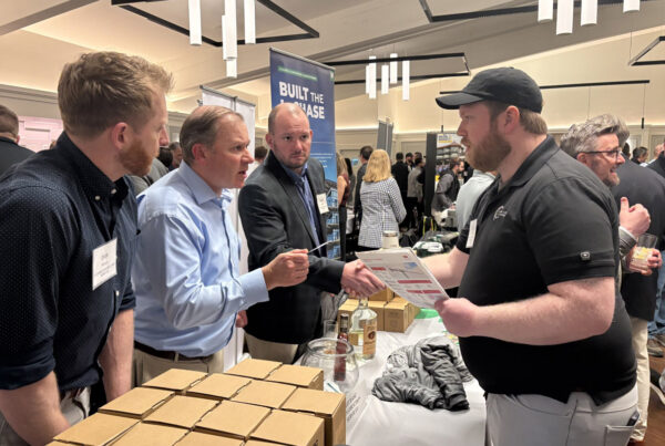 LeChase team meeting with people at the Meet the Estimators Event