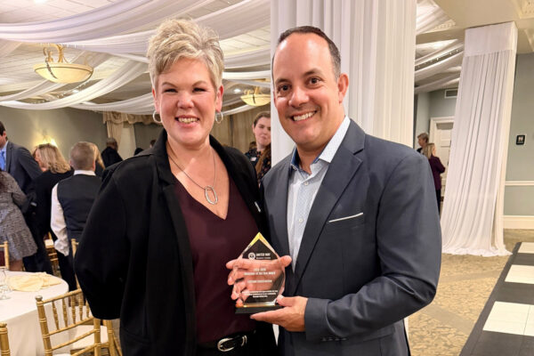 Michael Mauro accepting UW Volunteer of the Year Award on behalf of LeChase